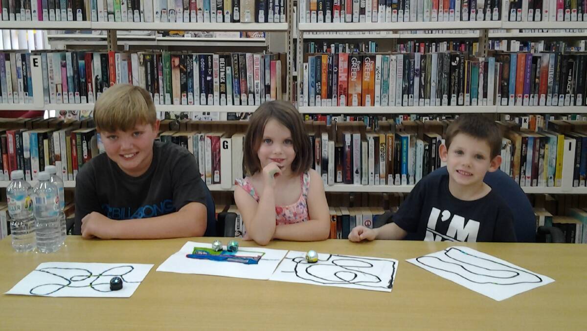 Benjamin Cannon, Grace and Joe Taylor designed their own tracks for Ozobot. Photo: CONTRIBUTED.