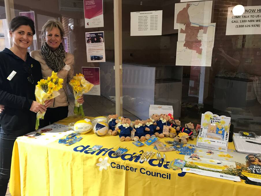 GUEST SPEAKER: Camilla Thompson and Judy Barlow selling Daffodil Day goods in August this year. Photo: CONTRIBUTED. 