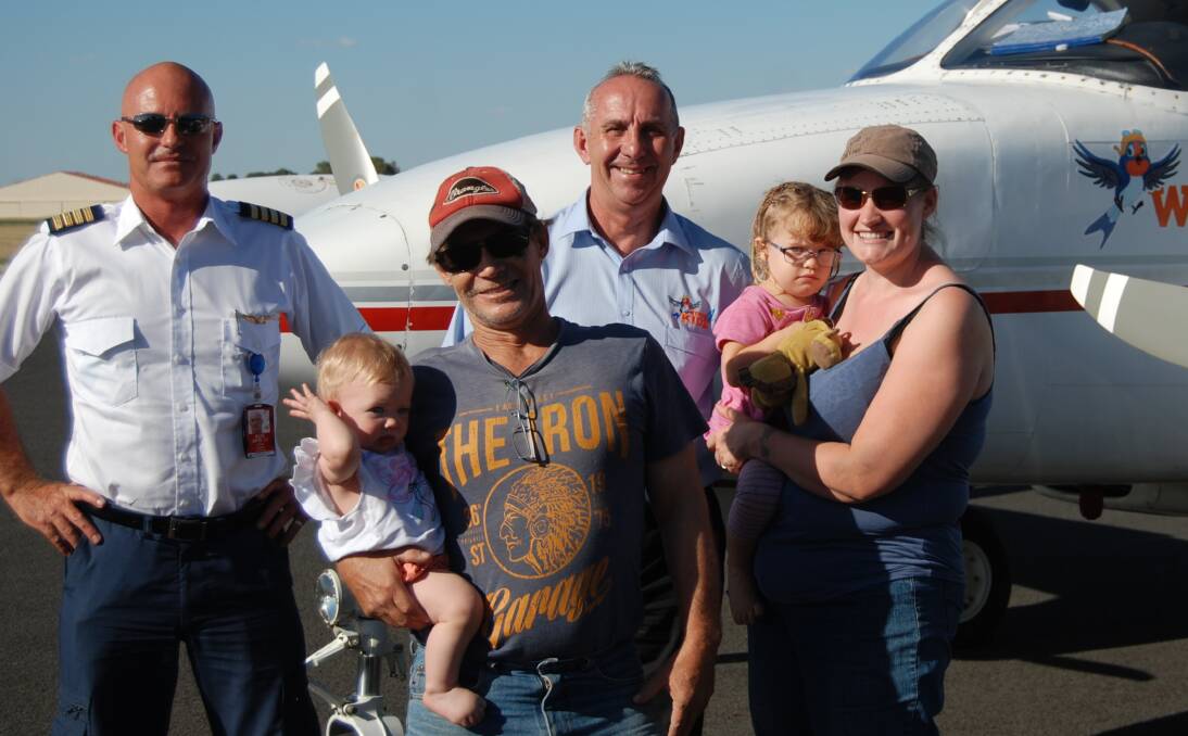 HELPING HAND: Pilot Chad Dunn with Wings4Kidz’s Kevin Robinson and Esther, John, Molly and Rachel Lillyman post landing at the Narromine Airport after one of the family's flights in February, 2016. Photo: GRACE RYAN.