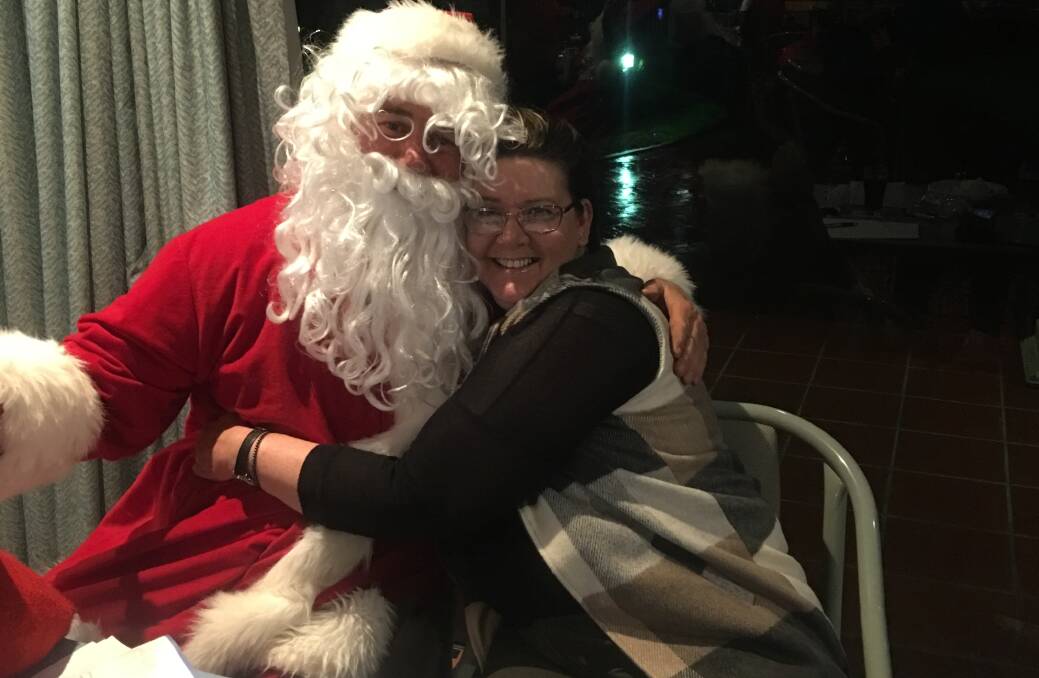 Santa made a special appearance for the all-red event, harnessing Christmas in July. Here he is with organiser Angela Hilder.