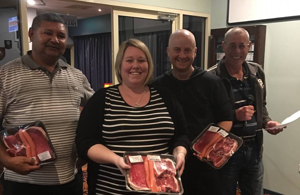 WINNERS ARE GRINNERS: Team 13 took home the highly coveted meat trays and the honour of  winning the July trivia.