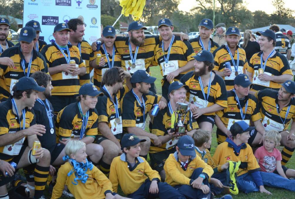 PREMIERS: The Trangie Tigers celebrate their massive premiership win with family and friends. Here they are with their medallians and the cup. Photo: CONTRIBUTED. 