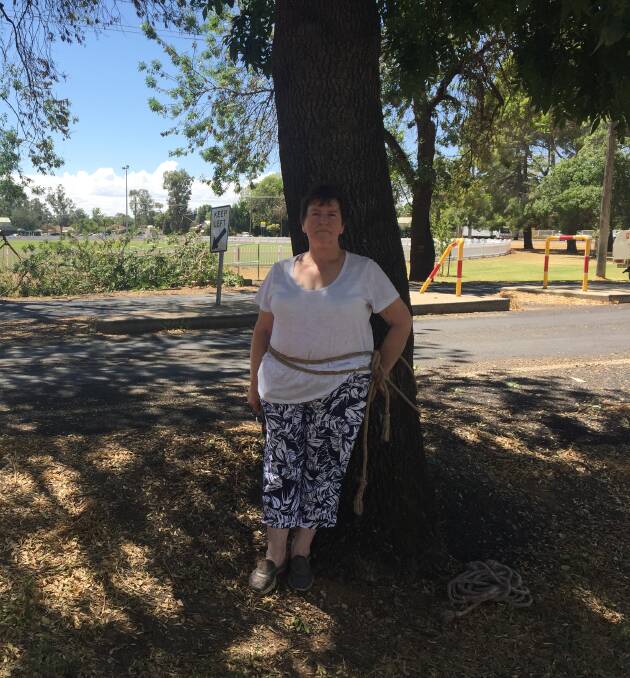 SAVE THE TREES: Julie Davis tied herself to a tree to prevent Essential Energy contractors from "mutilating" street trees in Narromine. Photo: CASSIE MILLER-COEN.