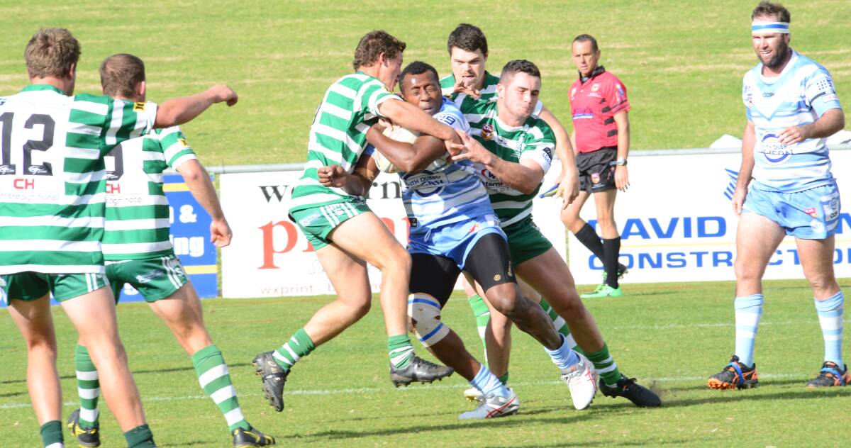 THAT TIME AGAIN: Macquarie's Eroni Turaga is wrapped up by the CYMS defence during the season's first Dubbo derby earlier this year. Photo: PAIGE WILLIAMS