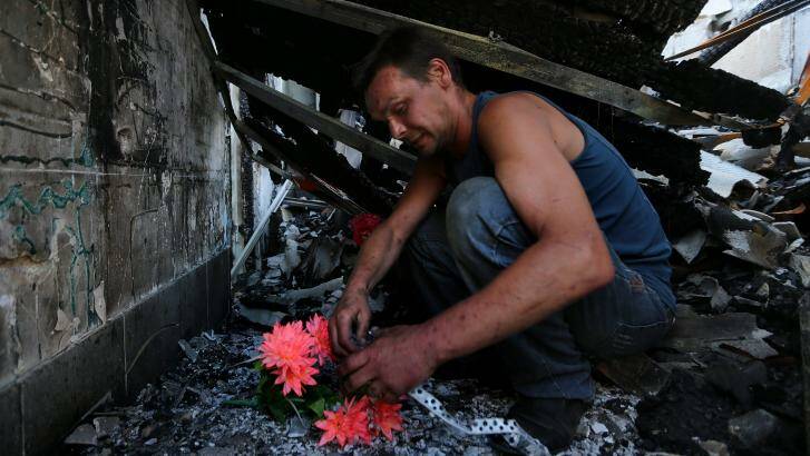 Dimitriy Gorozhaninov sits inside the remains of his families home where his father, mother, sister and wife died when a shell landed on the home in Petrovskiy on the outskirts of Donetsk. Photo: Kate Geraghty