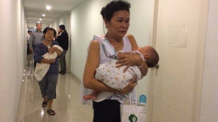 Offspring: Two of the babies found with surrogate mothers in a Bangkok condominium. Photo: Thai Rath TV