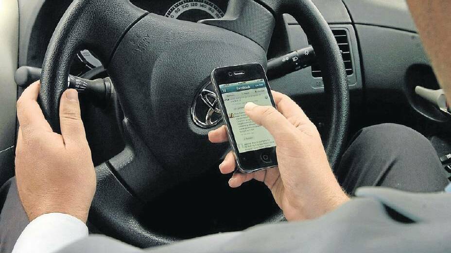 Tougher penalties are being introduced for mobile phone use while behind the wheel. Photo: STEVE GOSCH. 