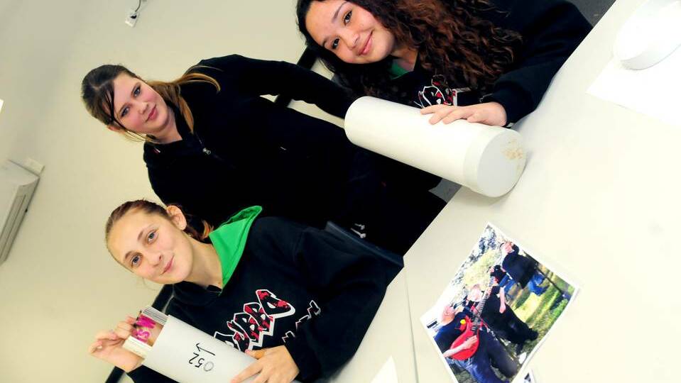 Dubbo College Delroy Campus students Oceanlee Eichhorn, Sky Robinson and Kiesha Nolan prepare their time capsules. Photo: LOUISE DONGES