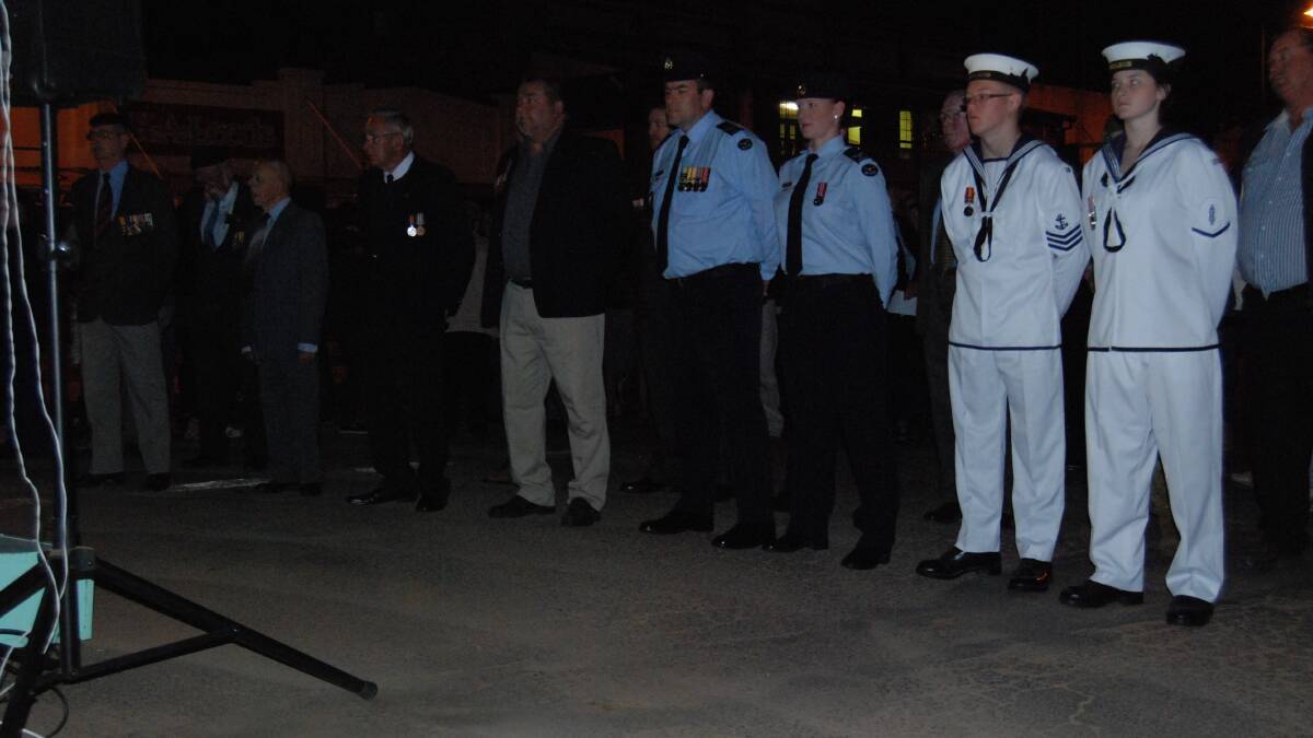 DAWN SERVICE: Returned and current members of the Armed Services stand at ease
