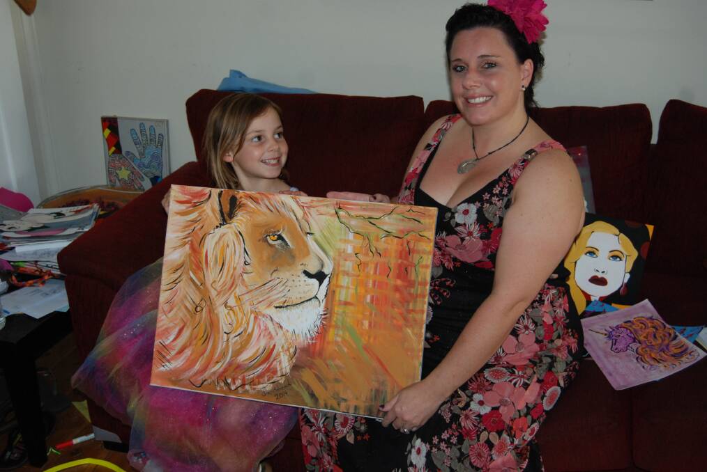 Sacha and her daughter Halli display some of her works