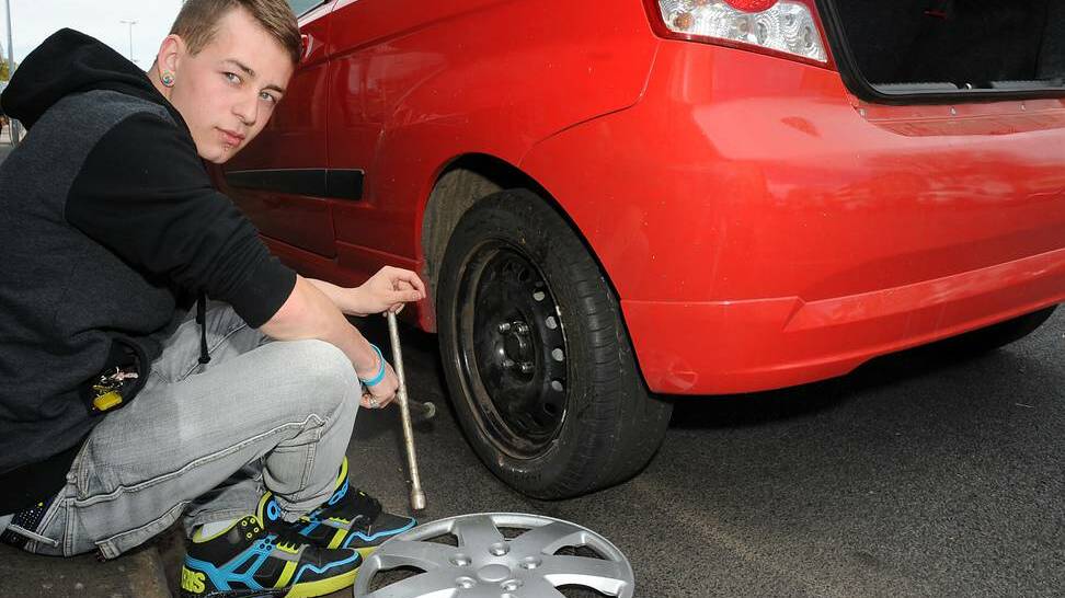 Nicholas Steepe and his car that has had eight tyres damaged beyond repair on purpose in the past three months. Photo: BELINDA SOOLE