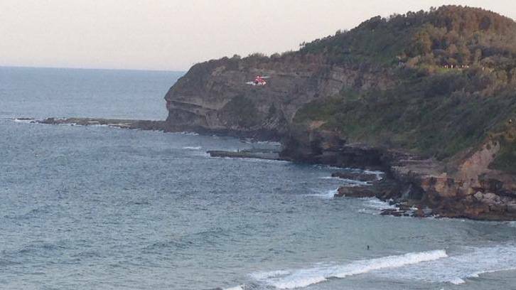 Cliff fall: a rescue helicopter arrives at Warriewood beach.