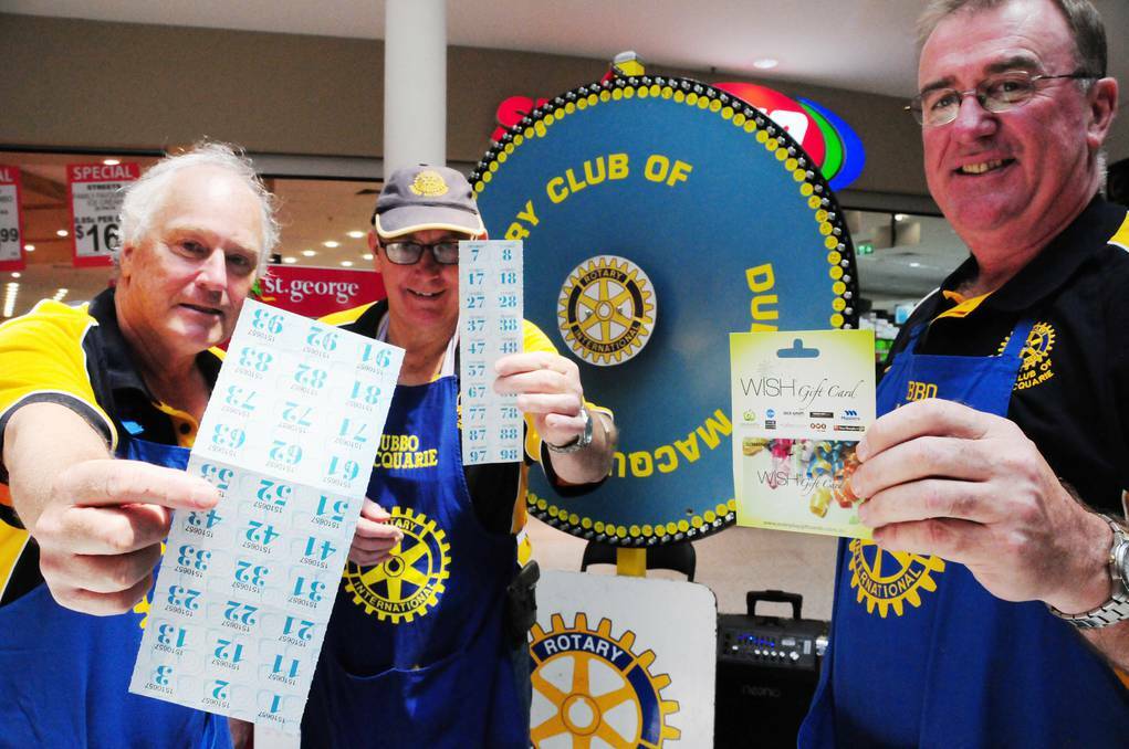 Peter Stanford, Peter Kuhner and Gerard O'Leary are excited the Rotary Club of Dubbo Macquarie's chocolate wheel has begun spinning for its 11th consecutive year. Photo: GREG KEEN