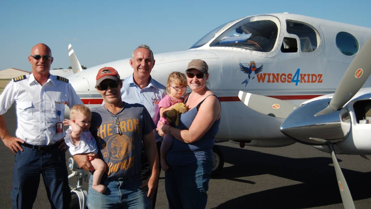 Pilot Chad Dunn with Wings4Kidz’s Kevin Robinson and Esther, John, Molly and Rachel Lillyman.