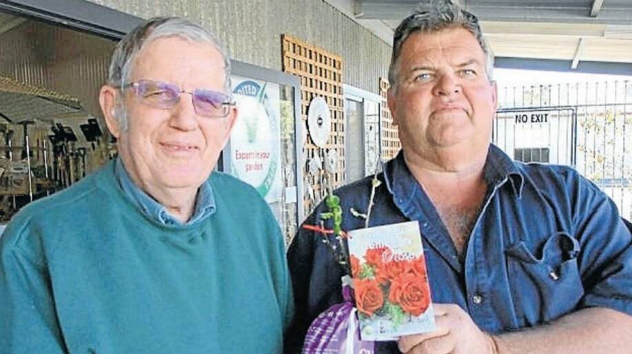 Edgerton Nursery has donated a Gallipoli Rose to the Narromine RSL Sub-Branch to be planted at the Narromine War Cemetery. Pictured is Greg Hitchcock presenting the Gallipoli Centenary Rose to the President of the RSL Sub-Branch Neil Richardson. Photo: CONTRIBUTED