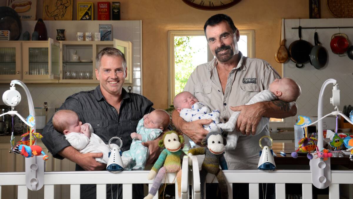  Chris and Michael with their two sets of twins after going through IVF in Thailand. Chris is holding Isabella and Melanie while Michael holds Jake and Logan. 
PICTURE: ADAM TRAFFORD
