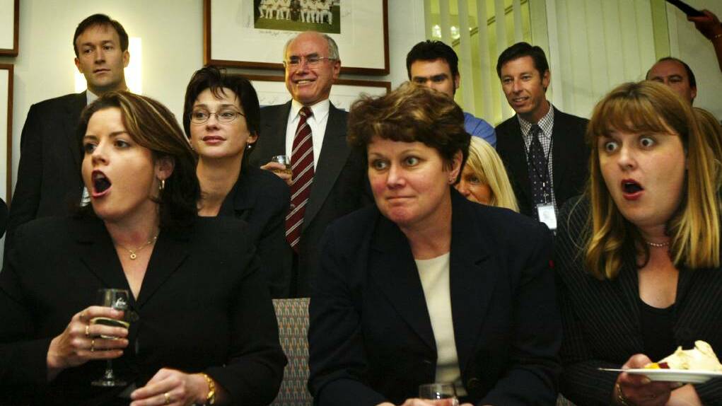Then Prime Minister John Howard and some of his Canberra staff watch the Melbourne Cup race on television in 2003. Picture: Andrew Taylor