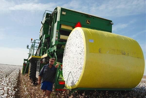 o Jake George shows off a newly formed round bale ready to drop behind the machine.