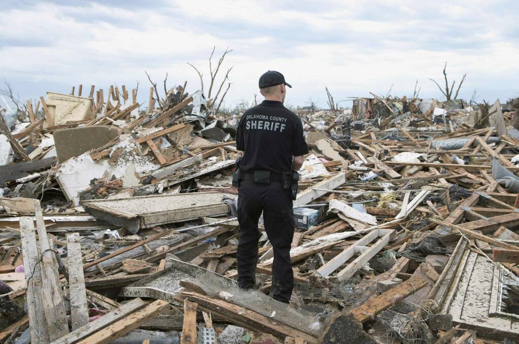Oklahoma County Sheriff's Deputy Erik Gransberg searches for victims in rubble at a residential area of Moore, Oklahoma May 21, 2013. Photo: REUTERS/Richard Rowe