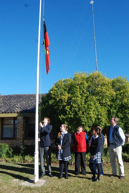 NAIDOC DAY: Jack Dolton raising the flag at Monday's ceremony. Pictured with him are Maddison Geyer, Thelma Williams, Lakeisha Hull and Mayor Bill McAnally.