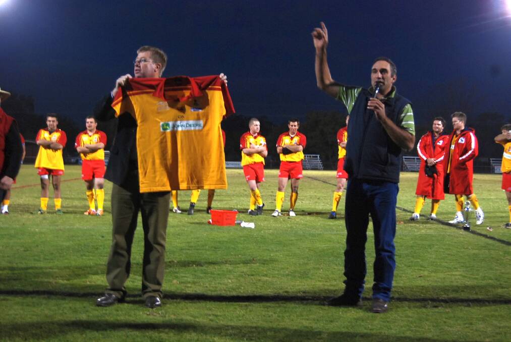 Local member Troy Grant displaying one of the jerseys. Auctioneer Ash McGilchrist was doing a great job at selling.
