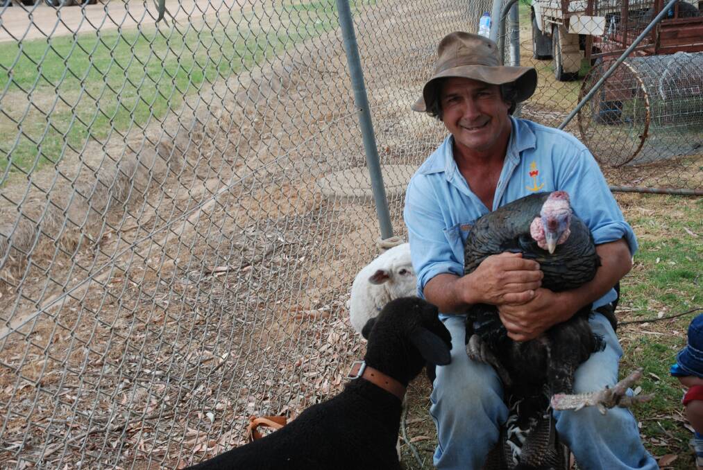 o John Clarke had his hands full at the animal stand.