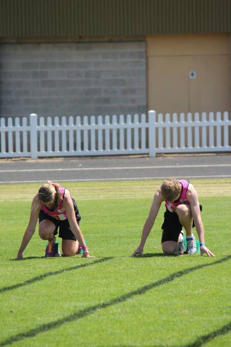 Narromine’s Caitlin Butcher and George Jackson preparing for the 100m sprint.