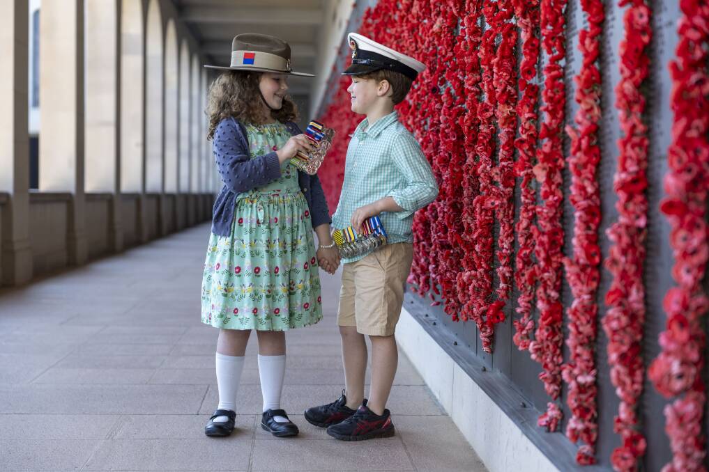 Lucas and Mathilda Berry share a moment at the Australian War Memorial. Picture by Gary Ramage