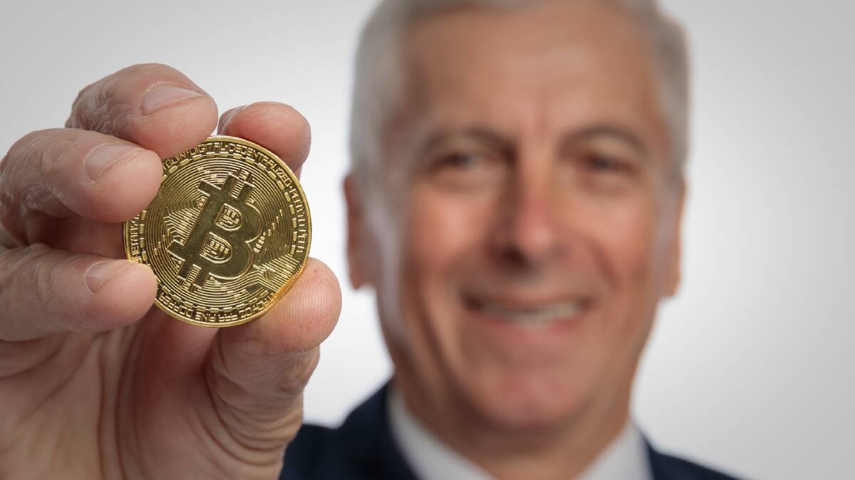 A man holds Bitcoin. Picture by Adobe Stock
