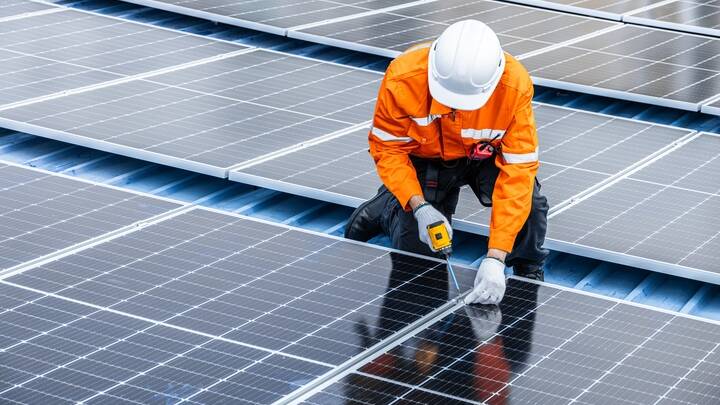 An engineer installs solar panels. Picture by Shutterstock