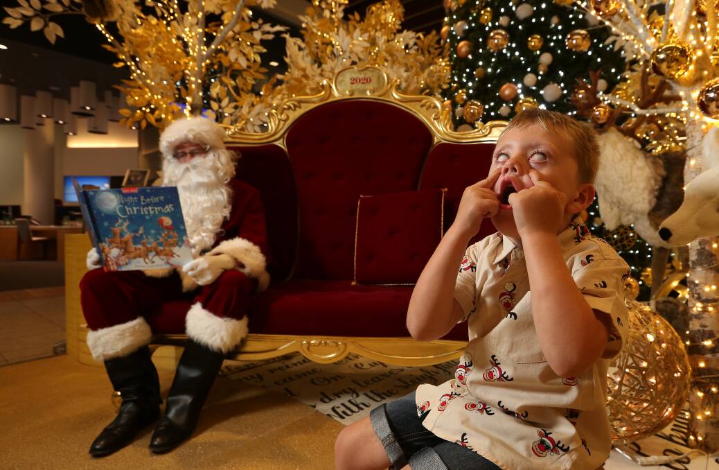 Yes little one, we agree, this year has been one giant eye roll. Nicholas Lambie shows his frustration at not being in touching distance of the beloved Santa Claus. Picture: Simone De Peak
