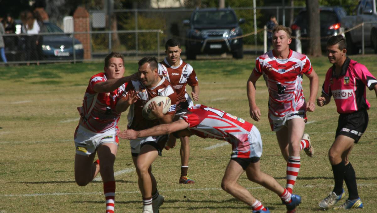 Showing Gilgandra: Captain coach Jamie Towney on the charge against Coolah last Saturday, referee Peter Evans. Photo: Stephen Basham.