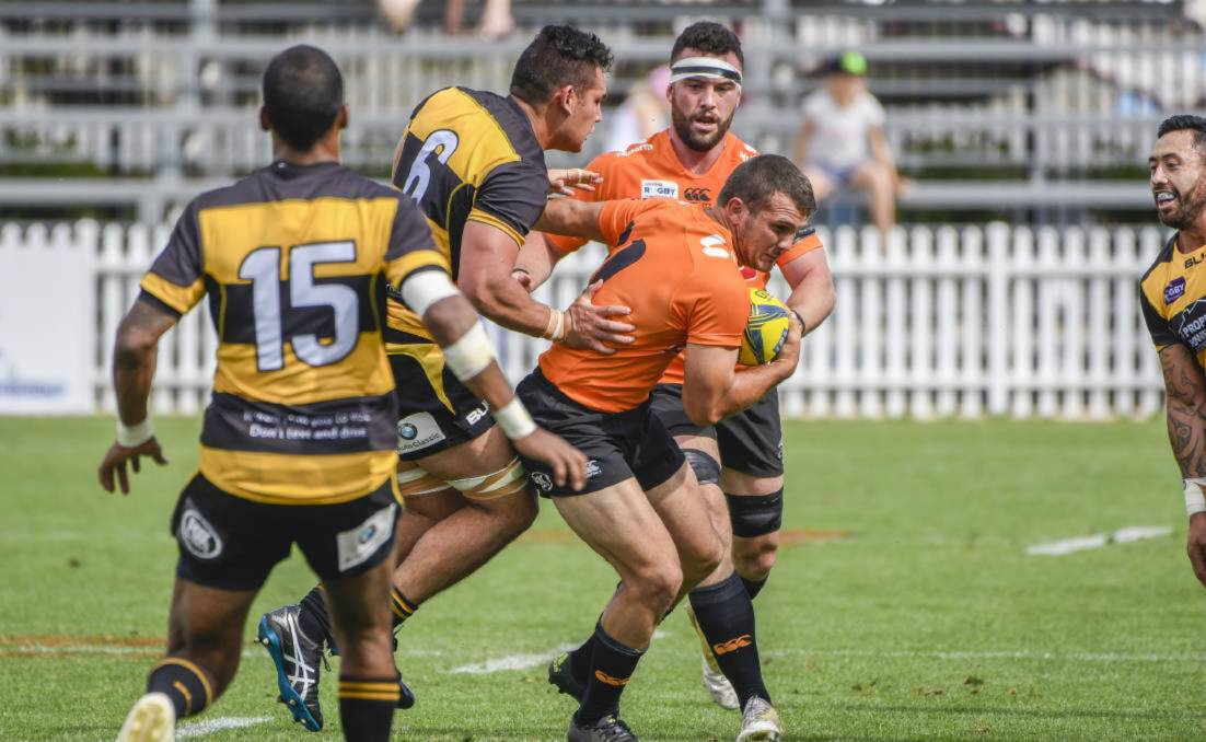 BREAKING THROUGH: Pat McCutcheon fends of a Perth Spirit defender in Saturday's game against the reigning NRC champions at Scully Park in Tamworth. Photo: PETER HARDIN. 