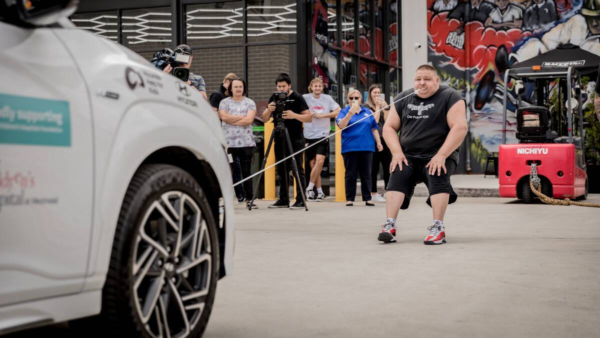 Strength: Troy Conley-Magnusson pulling cars with his teeth. Picture: Tenille Salmon Soul Images