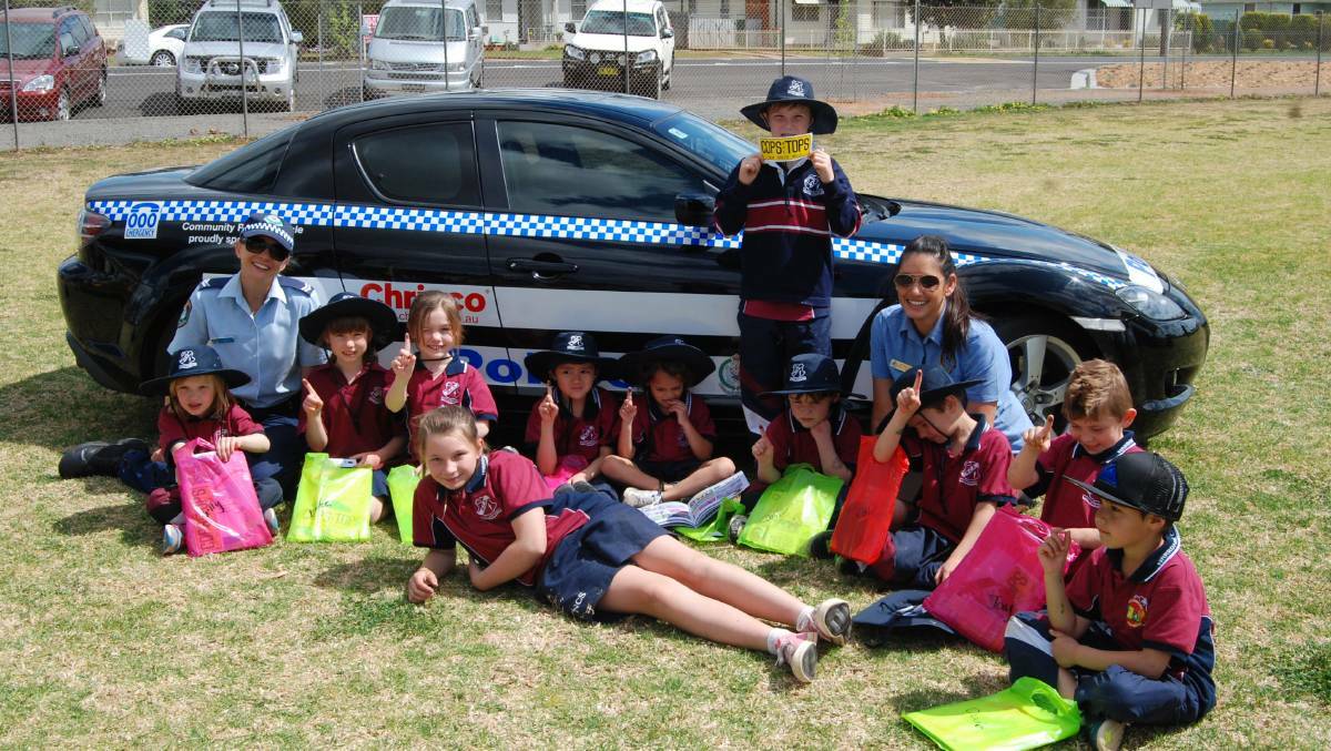 'F' is for fingerprinting the Christian School kindergarteners learn from Senior Constable Jodie Male Orana LAC and Kristy Night ACLO from Orana Police.