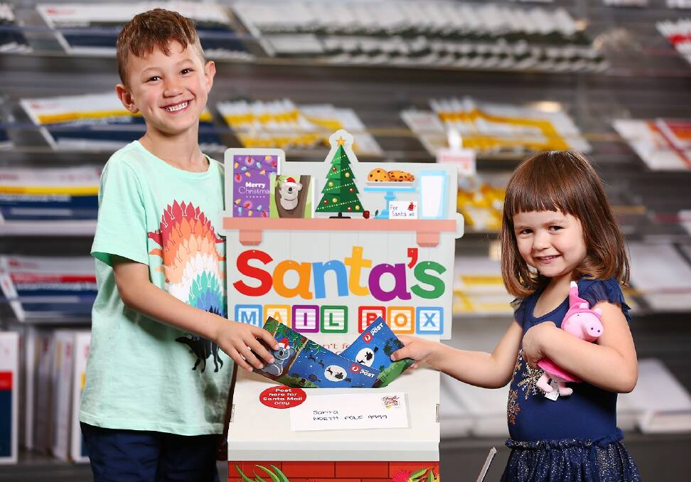 SANTA CLAUS COMING TO TOWN: Flynn and Lillia post their letters to Santa. Photo: Supplied