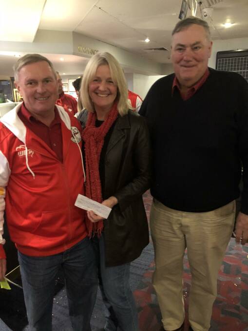 Nikki McCutcheon and Neville Roberts from the Narromine Cancer Support Group receiving a cheque from Archie Harding at the recent Jets football club auction.