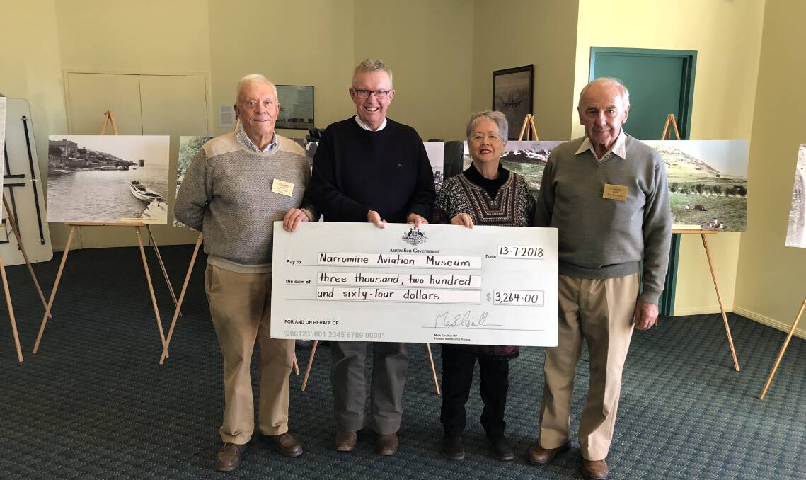 BOOST: Member for Parkes Mark Coulton presented $3264 to members of the Narromine Aviation Museum for Armistice commemorations. Photo: Contributed 