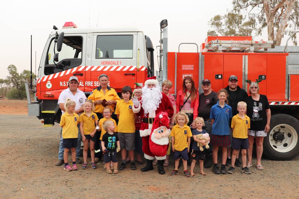 MERRY CHRISTMAS: Students at Hermidale Public School have received some early Christmas cheer when Santa rolled into town. Photo: ZAARKACHA MARLAN