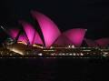The sails of the Sydney Opera House are lit up with the colour pink as a tribute to Olivia Newton-John. Photos: AAP Image/Steven Saphore