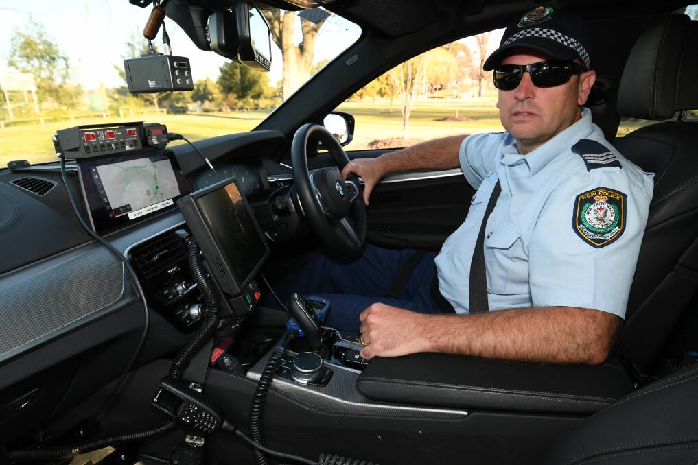 STATE-OF-THE-ART: Sergeant Chaplin inside the Highway Patrol car, which is effectively a mobile office.