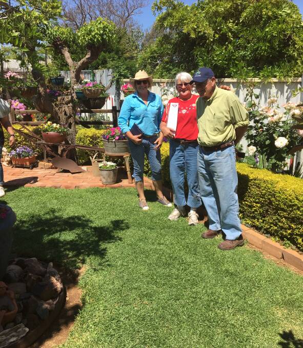 Kath Cross, showing Cheryl Terry and Mal Carpenter her garden. Photo: Contributed