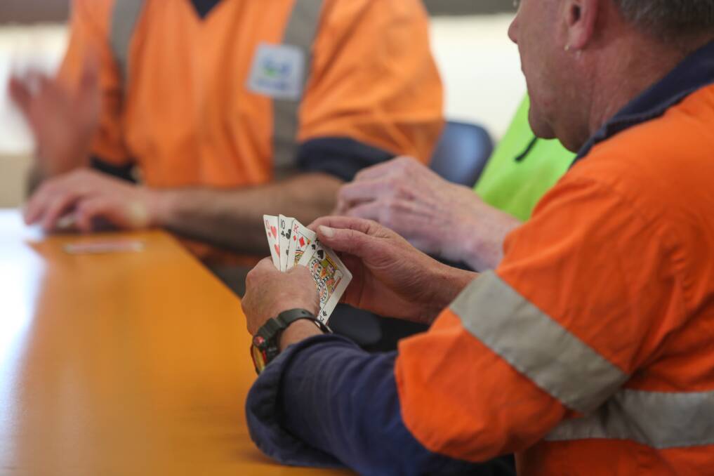 Workers entertain themselves with a game of cards during a lunch break. Picture: Rob Gunstone