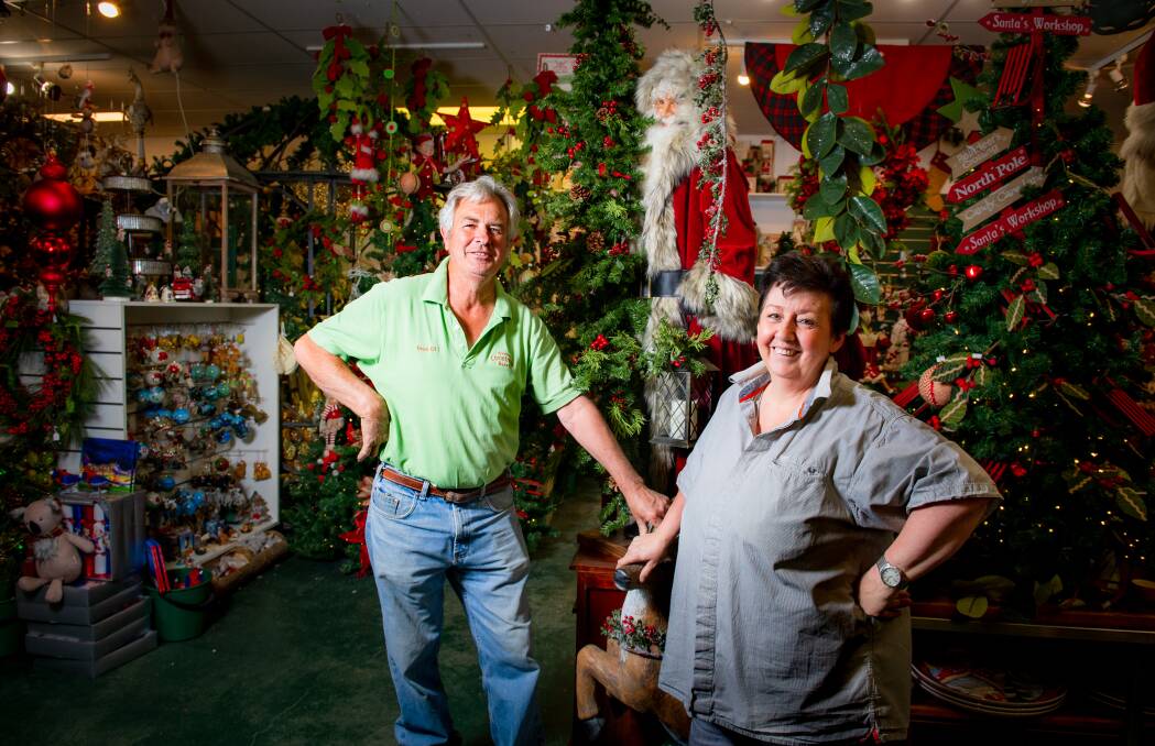 Owners of the Christmas Barn, Neville and Leanne de Smet, with one of the Ditz Designs limited edition Santas. Picture: Elesa Kurtz