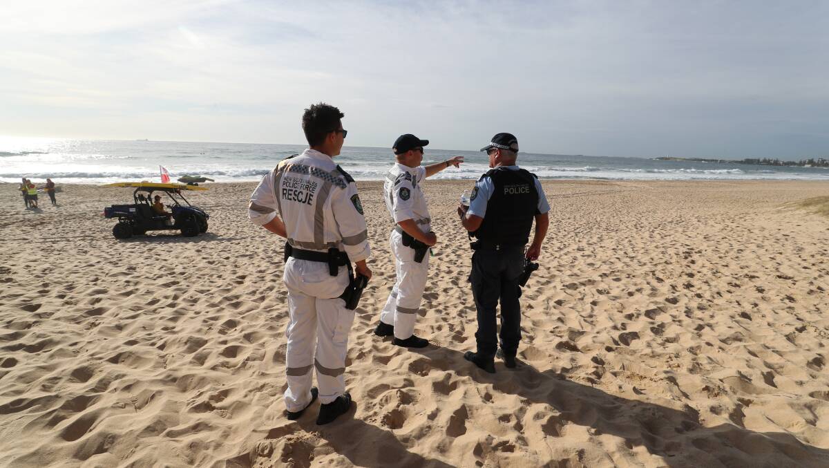 Police on Fairy Meadow Beach on Monday, October 30 during the search for a missing swimmer. Picture by Robert Peet