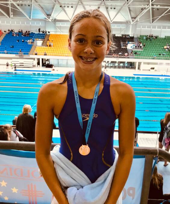 MAKING A SPLASH: Maddie Marks with her 200m IM bronze medal at the NSW PSSA Swimming Championships last month. Photo: SUPPLIED