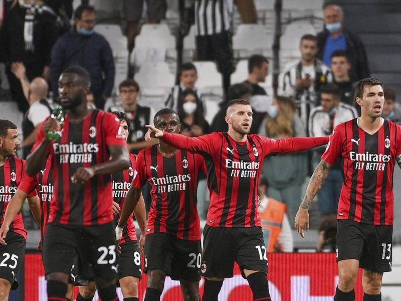 Ante Rebic, arms outstretched, celebrates his equaliser for AC Milan in the 1-1 draw at Juventus.