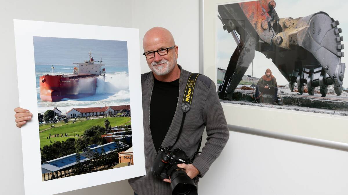 Picture Perfect: Murray McKean with his iconic photograph of the Pasha Bulker, which has been viewed millions of times. Picture: Jonathan Carroll