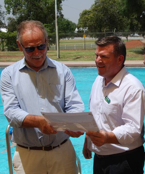 SWIM TIME: Narromine Shire mayor Craig Davis and Dubbo MP Dugald Saunders with the plans for the learn-to-swim pool. Photo: ZAARKACHA MARLAN