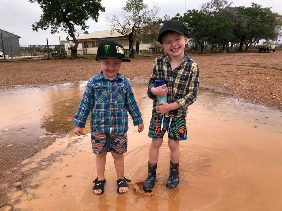 RAINY WEEKEND: These young fellas were enjoying a big rain dump near White Cliffs.